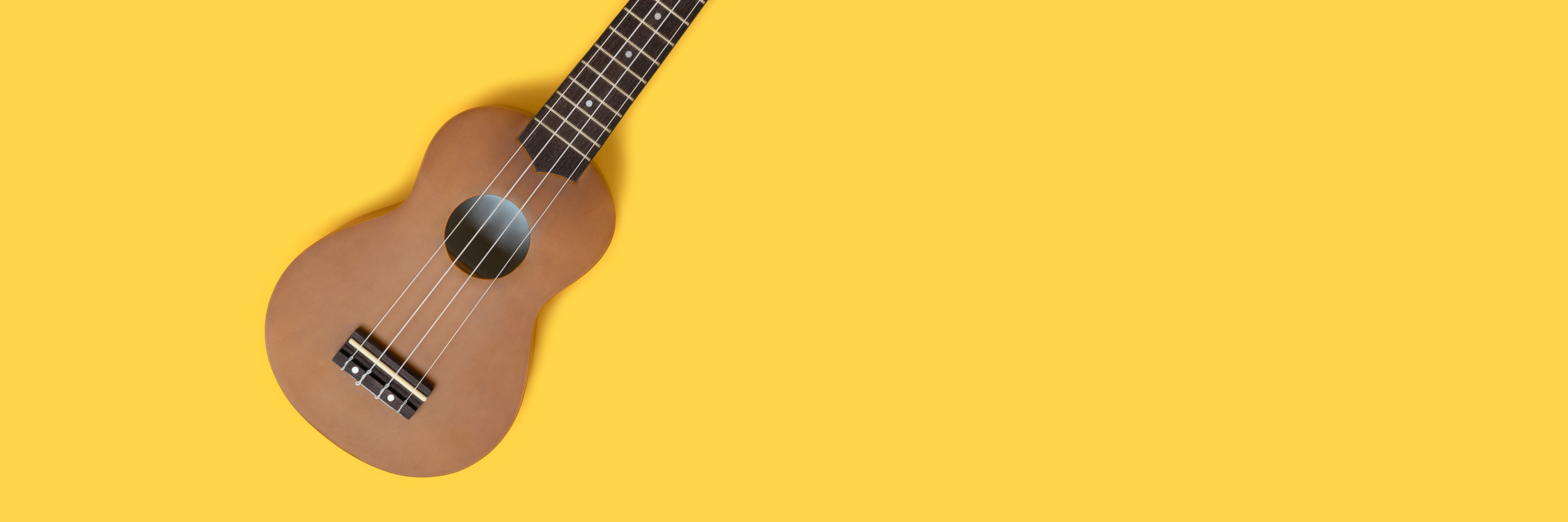 Ukulele on Yellow Background